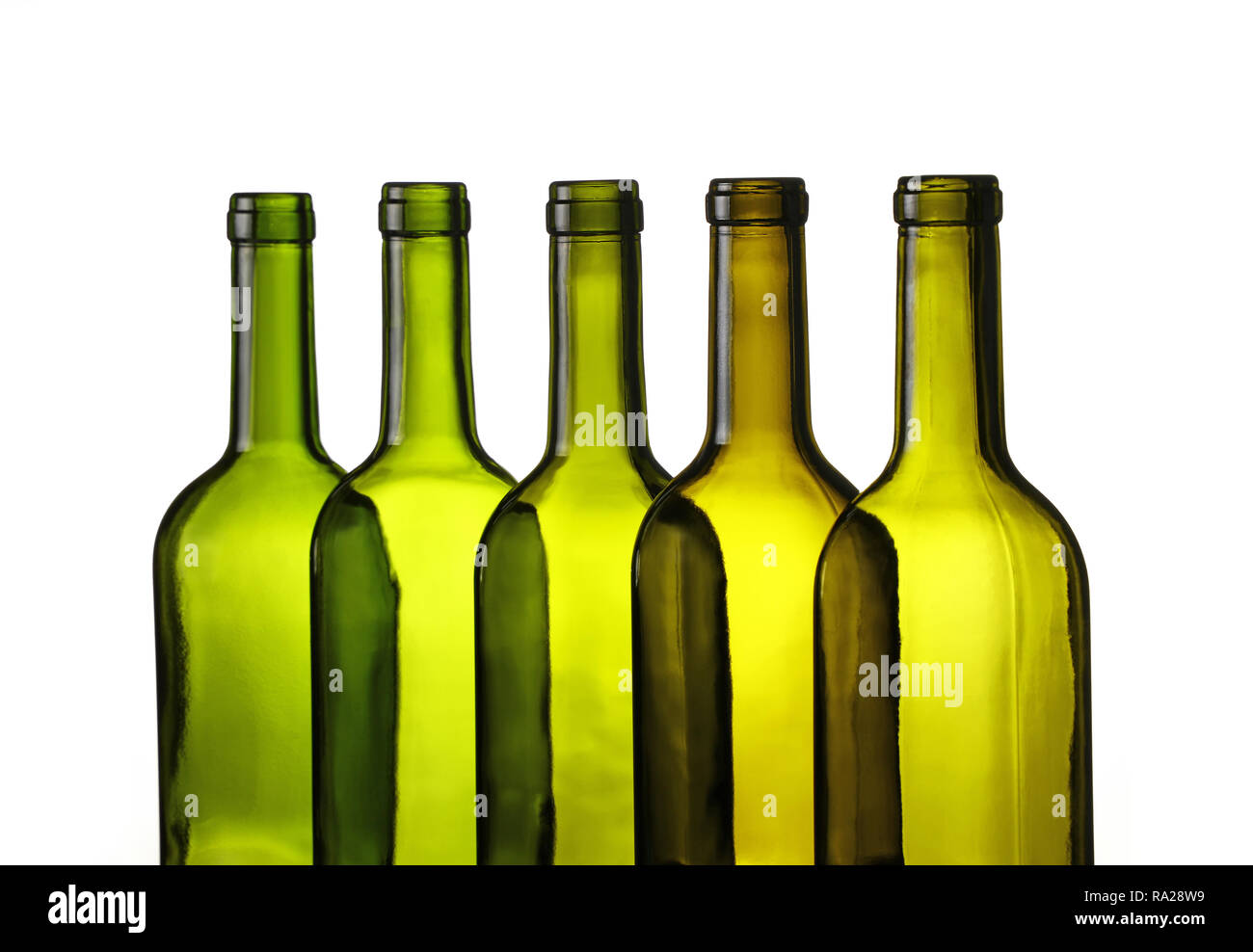 Close up group of five empty washed green glass wine bottles in a row isolated on white background, low angle side view Stock Photo