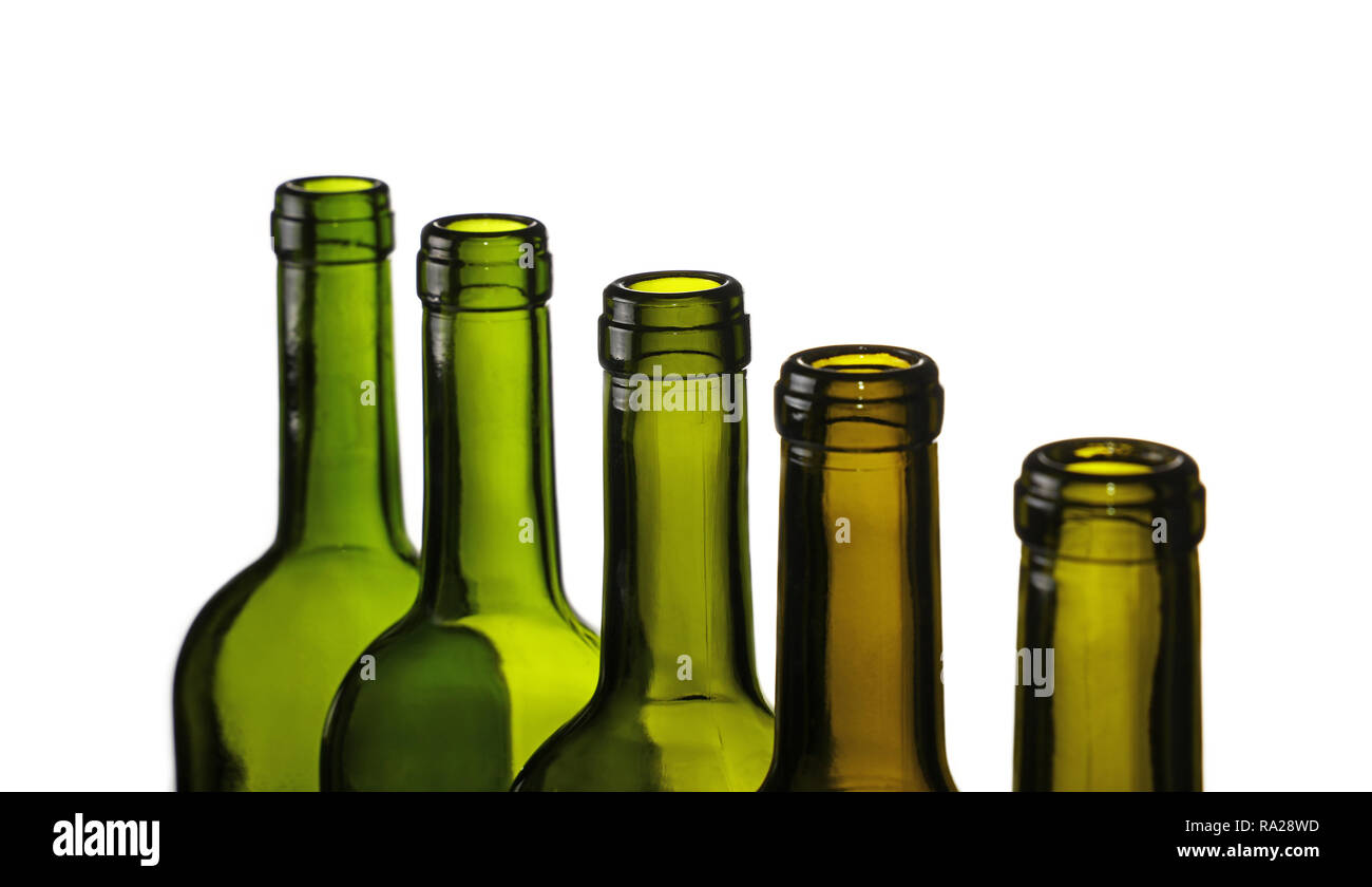 Close up group of five empty washed green glass wine bottles in a row isolated on white background, high angle side view, diminishing perspective Stock Photo