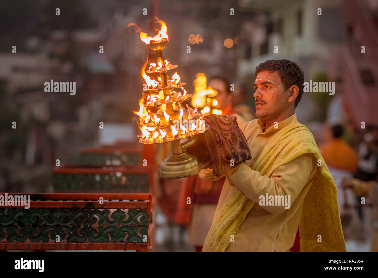 Traditional Fire ceremony in Rishikesh India, Indian man performing Pugea rituals. Stock Photo