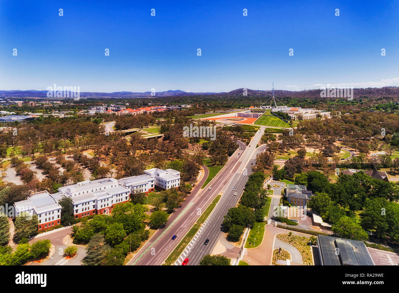 Wide multi lane Commonwealth avenue leading to Capital hill and parliament house in the middle of Canberra city of Australian Capital Territory in aer Stock Photo