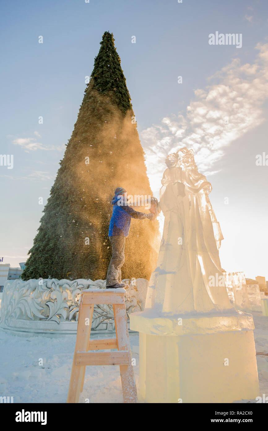 The Sculptor Cuts The Ice Figure Of Santa Claus For - 