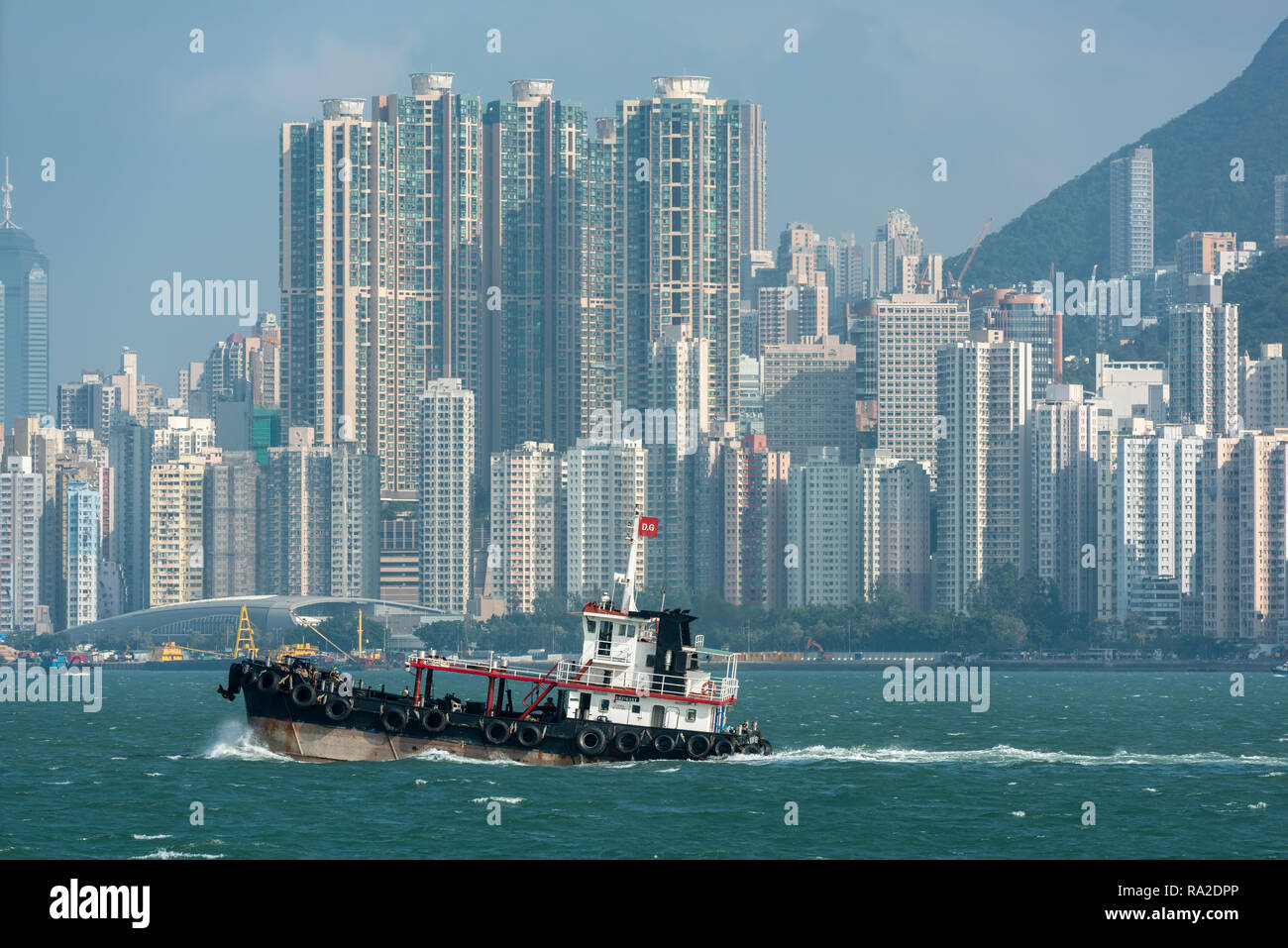 The tugboat 'Sun Chun 5'in Sulphur Channel with the high rise apartments of Kennedy Town in the background Stock Photo