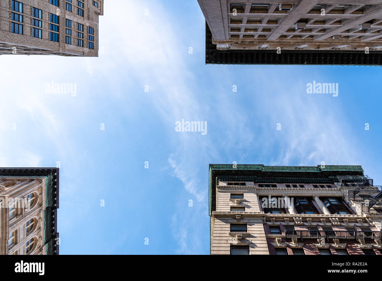Low angle view of old apartment buildings in Tribeca, New York. Directly below view against blue sky Stock Photo