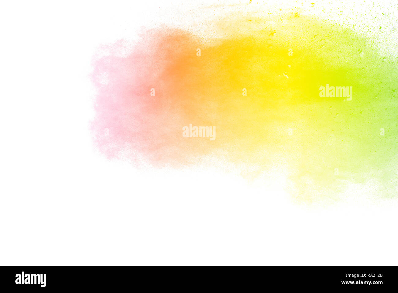 Freeze motion of color particles on white background. Multicolored granule of powder explosion. Abstract color dust overlay texture. Stock Photo