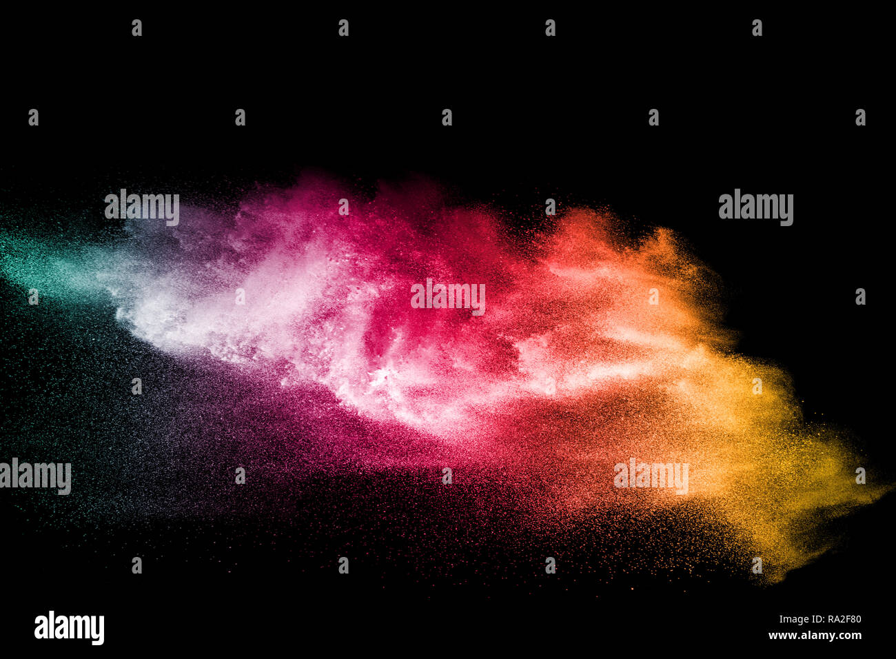 color powder explosion cloud isolated on black background. Freeze motion of color dust  particles splash. Stock Photo