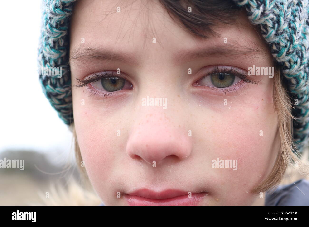 Closeup of a frustrated green eyed little girl that is close to tears Stock Photo