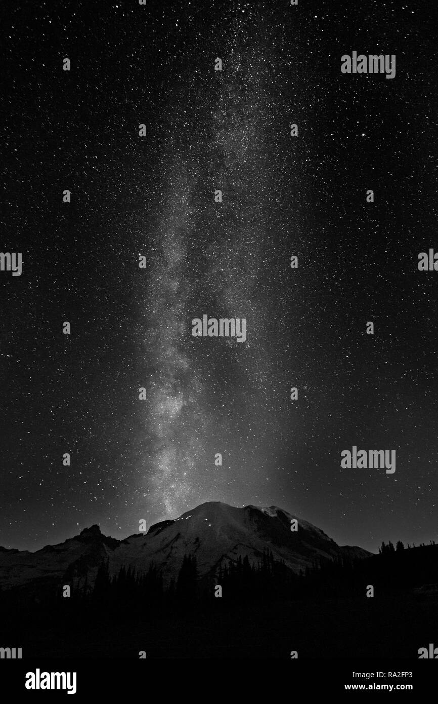 WA15644-00...WASHINGTON - The Milkyway over the summit of Mount Rainier from Sunrise in Mount Rainier National Park in black and white. Stock Photo