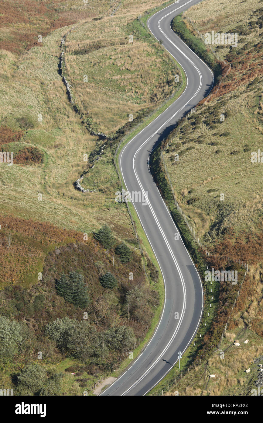 A curving, meandering road in the countryside of west Wales, United