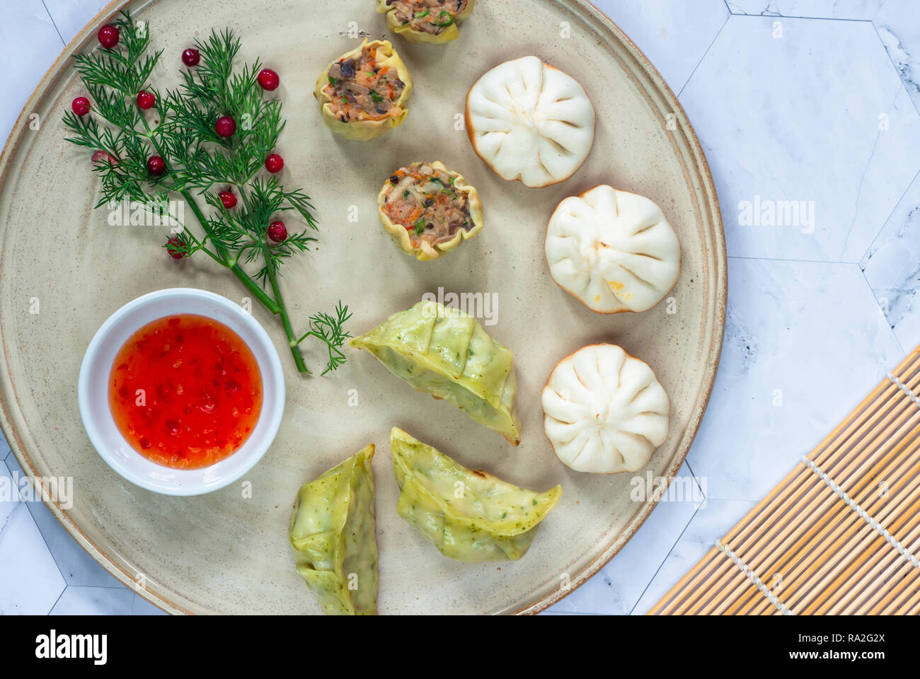 Selection of mini Chinese dumplings dim sum with sweet chili dipping