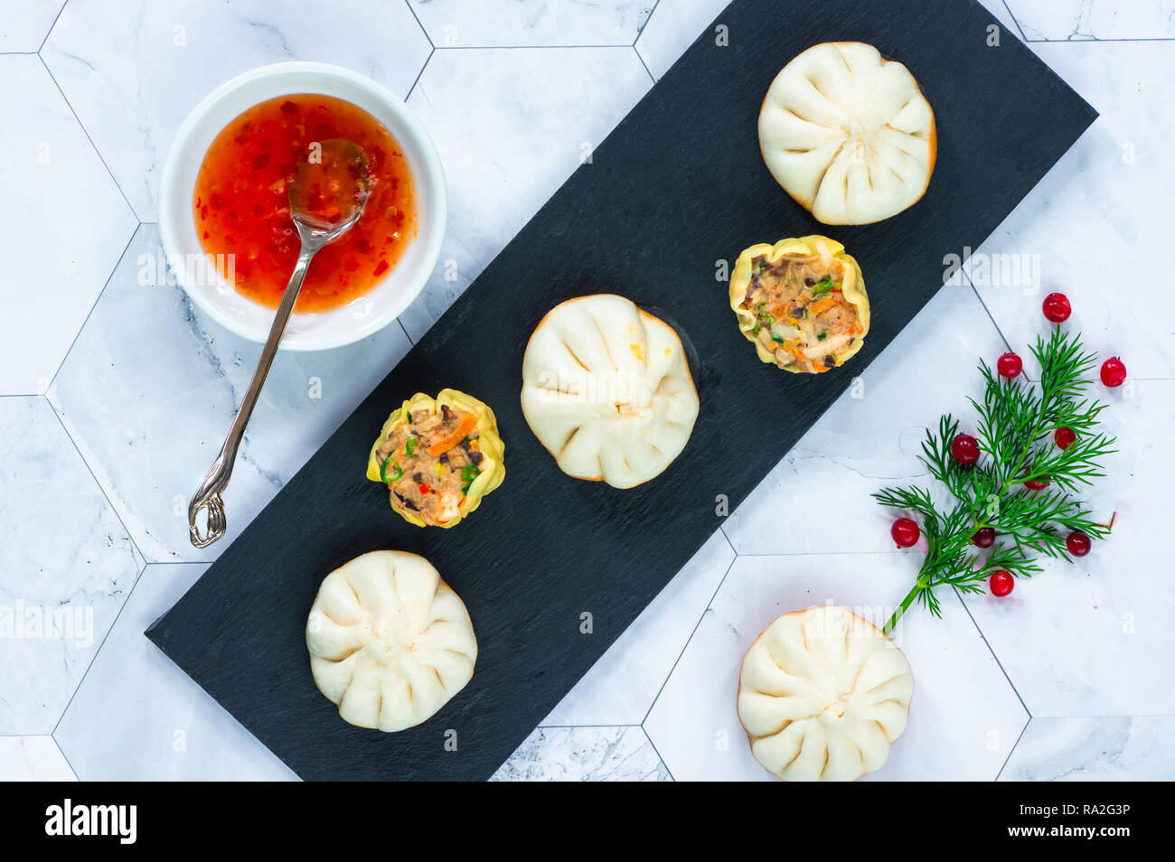 Selection of mini Chinese dumplings dim sum with sweet chili dipping