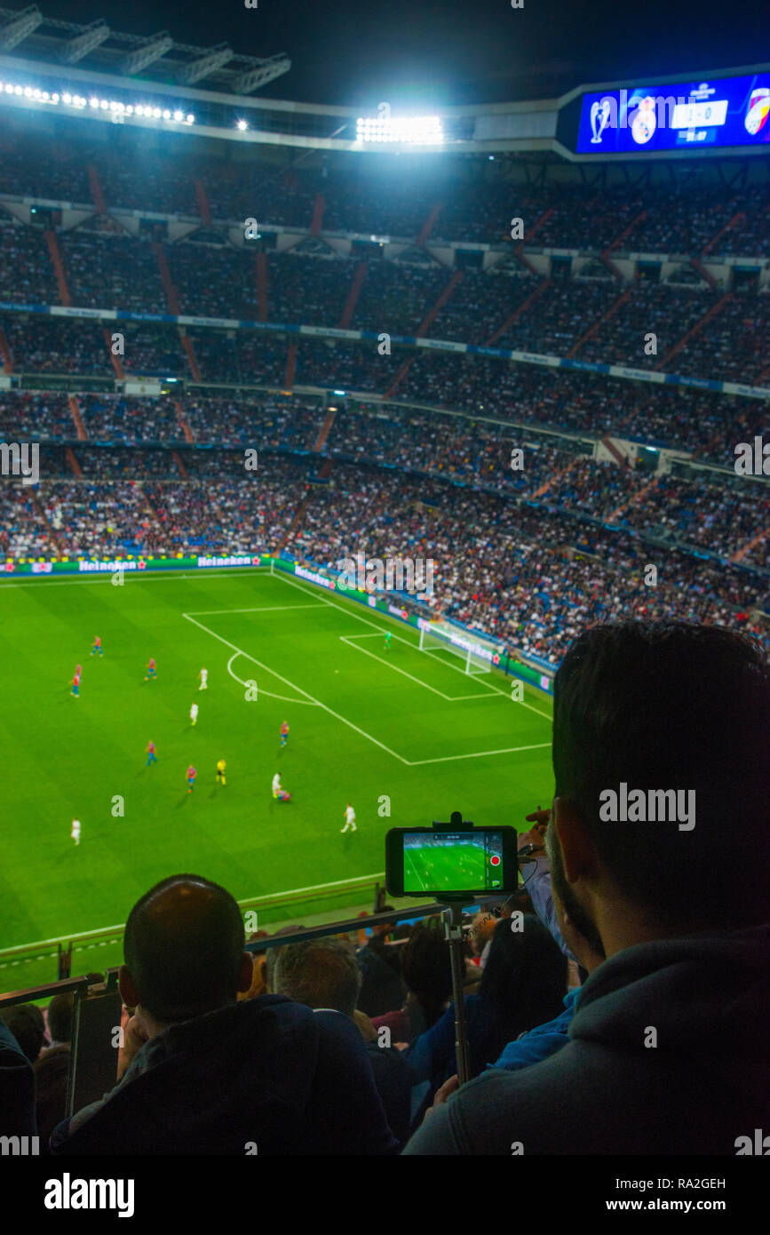 Spectators during a Champions League football match. Santiago Bernabeu stadium, Madrid, Spain. Stock Photo