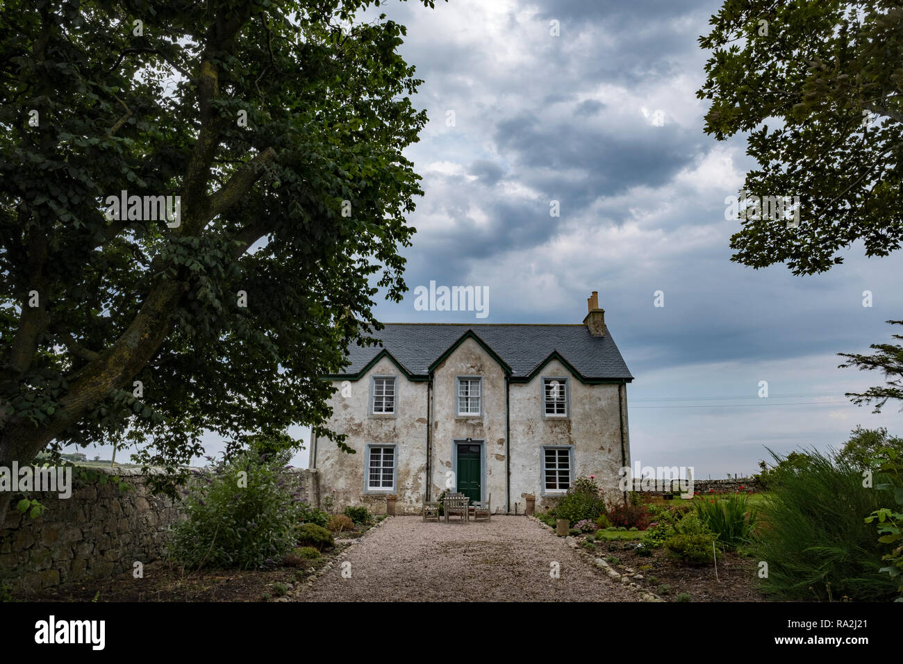 A manor house with landscaped garden and adjoining farmland in the Kyle