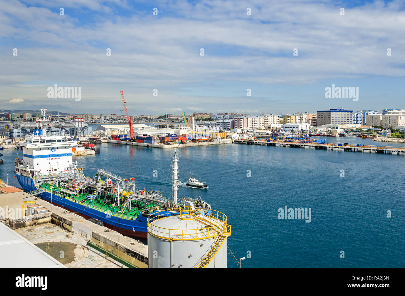 Gibraltar, British Overseas Territory -  November 8, 2018: Harbor and the Bay of Gibraltar with its colorful rail cranes, containers, ships and  boats Stock Photo