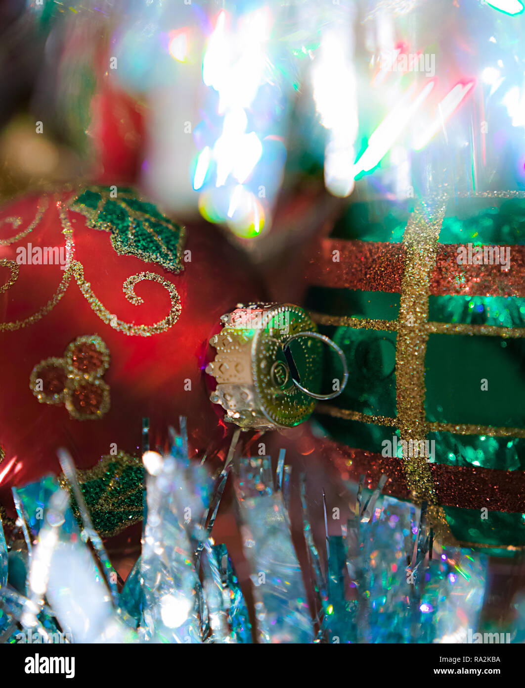 Two richly decorated, one red, one green, Christmas balls in close up. Stock Photo