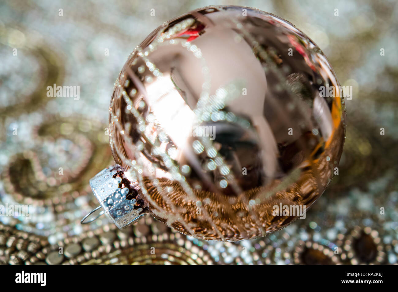 A richly decorated Christmas ball and table decoration, all in gold color. Close-up. Stock Photo