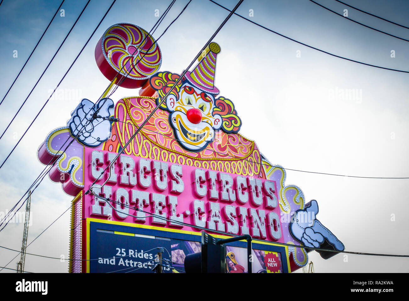 Neon sign in daytime of the Circus Circus Hotel and Casino, in Las Vegas, NV with it's outdoor Clown sign surrounded by electrical lines overhead Stock Photo