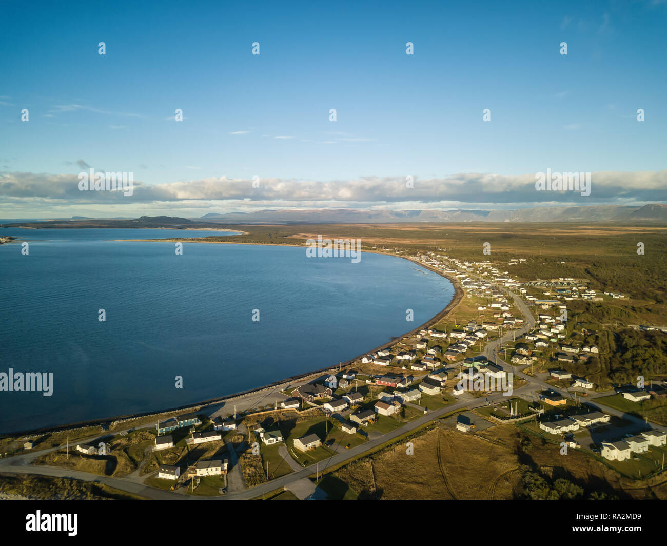 Aerial view of a small town on the Atlantic Ocean Coast during a vibrant sunny sunset. Taken in