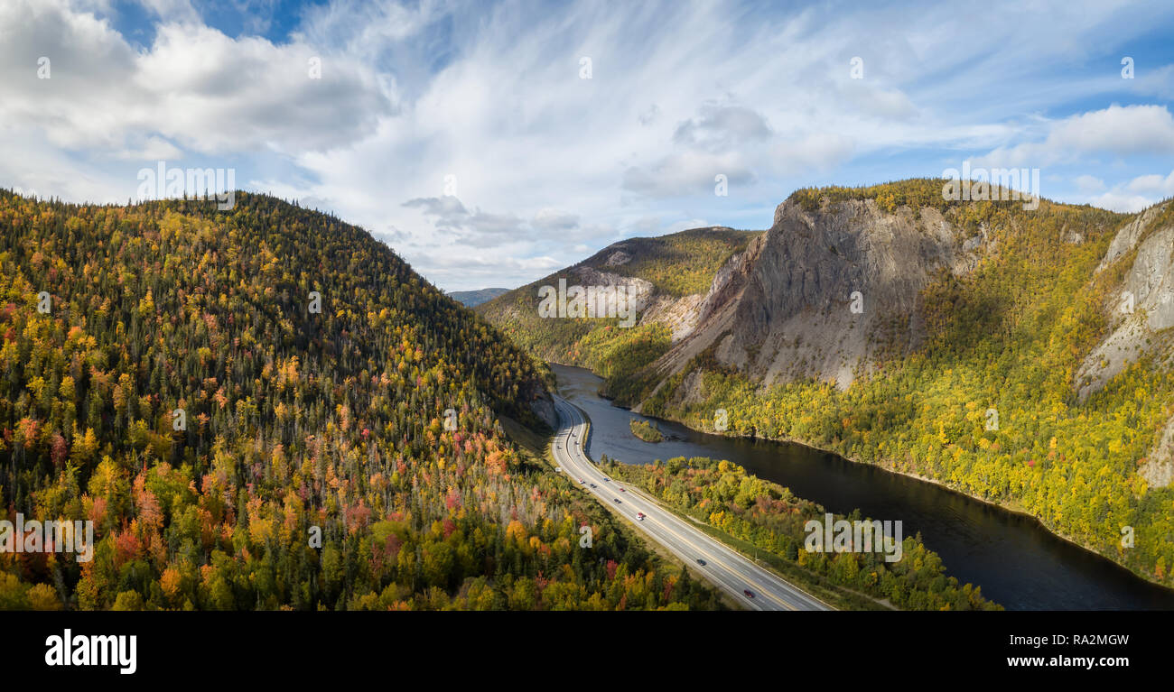 Aerial panoramic view of a scenic road during a vibrant sunny day