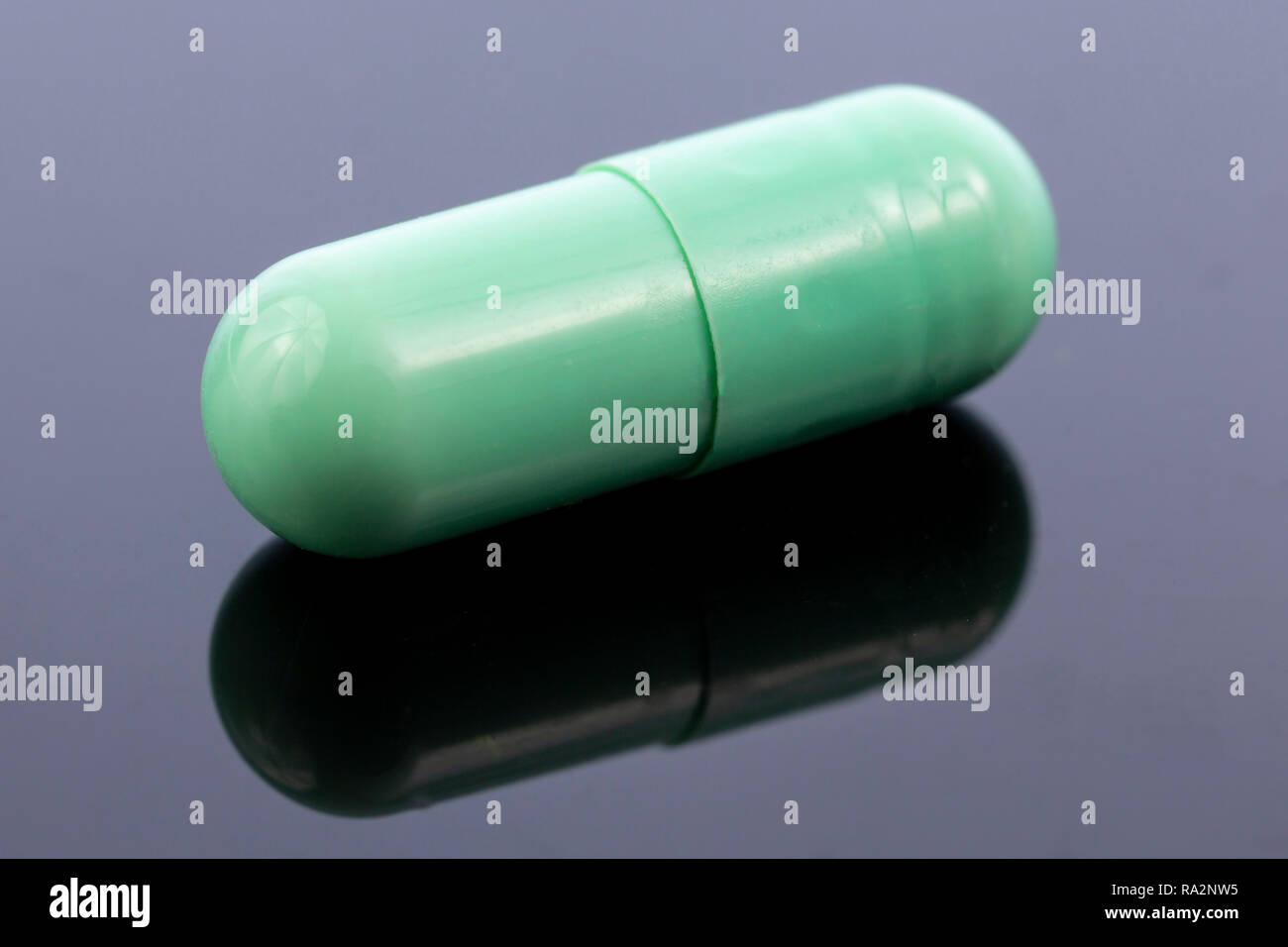 Single Green Capsule Isolated On Black Reflective Surface Global Pharmaceutical Industry For Billions Dollars Per Year Pharmaceutical Drugs For Use Stock Photo Alamy