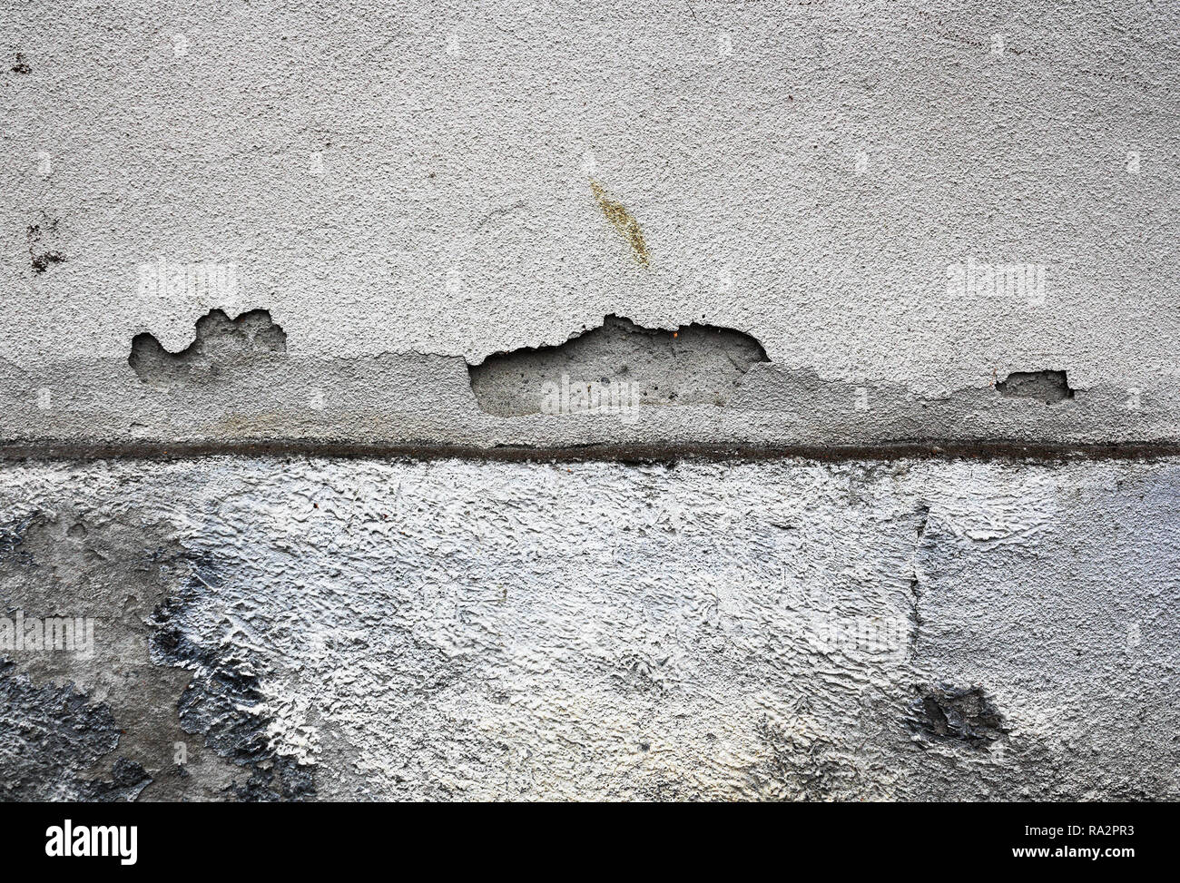 cracked plaster surface on damp exterior wall of old house Stock Photo