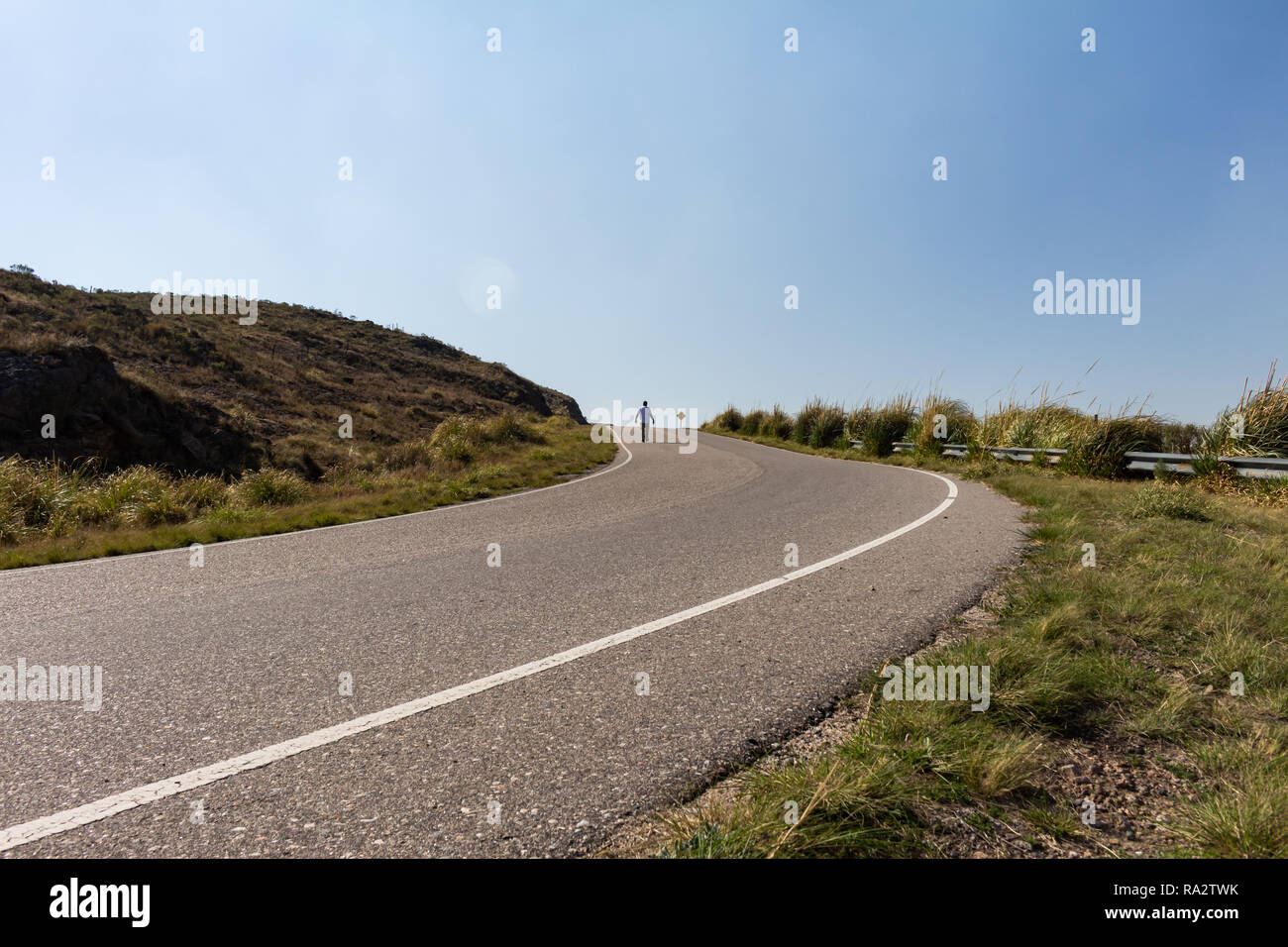 Man walking on the route. Rural landscape. Walking on the road. Stock Photo