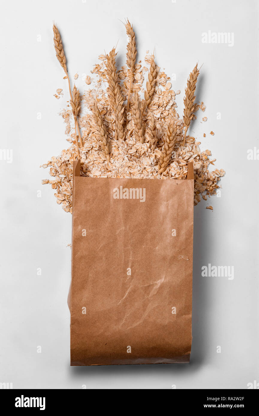 oatmeal in paper bag on white background Stock Photo