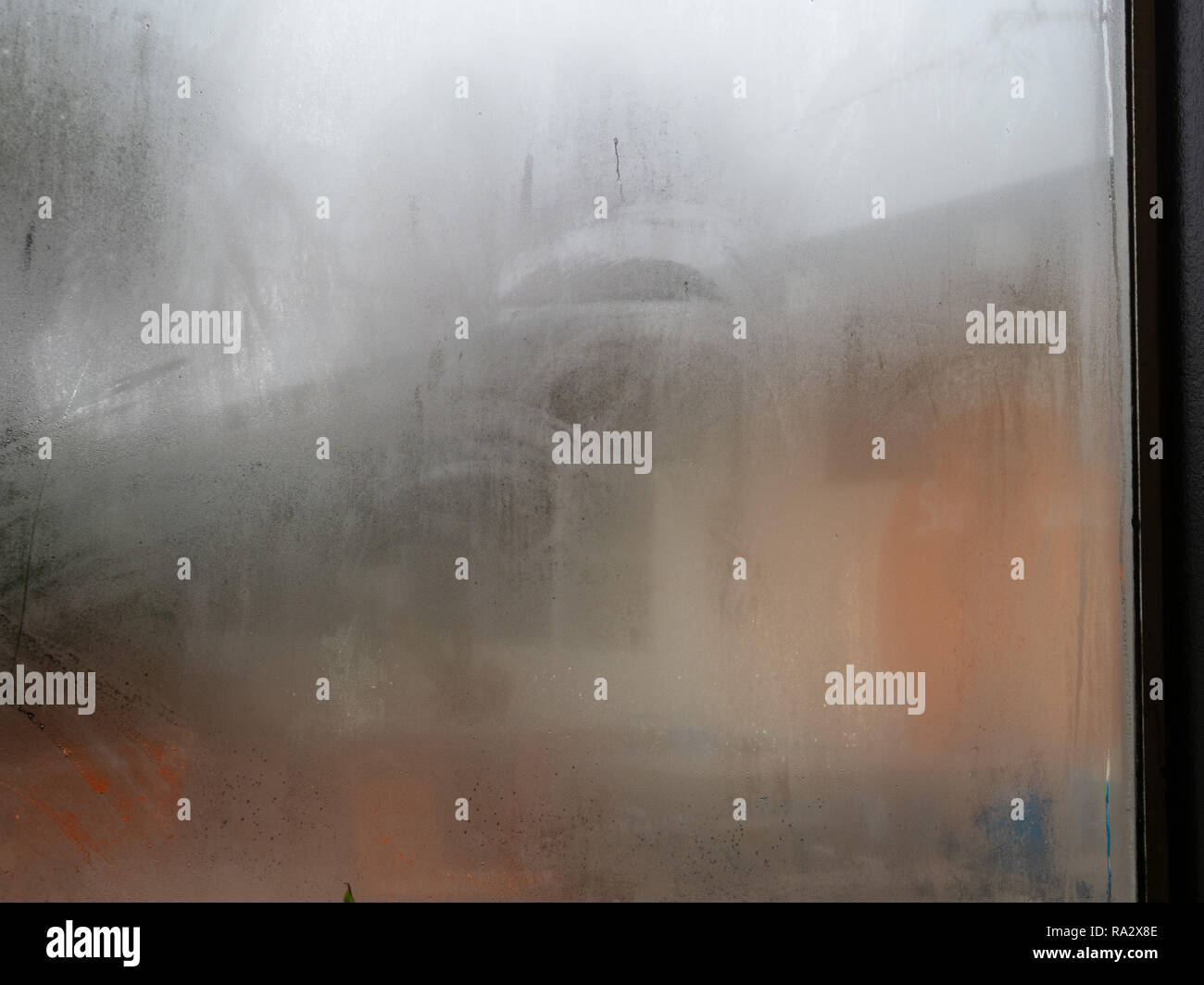 Window in store covered in fog and condensation from the indoors Stock Photo