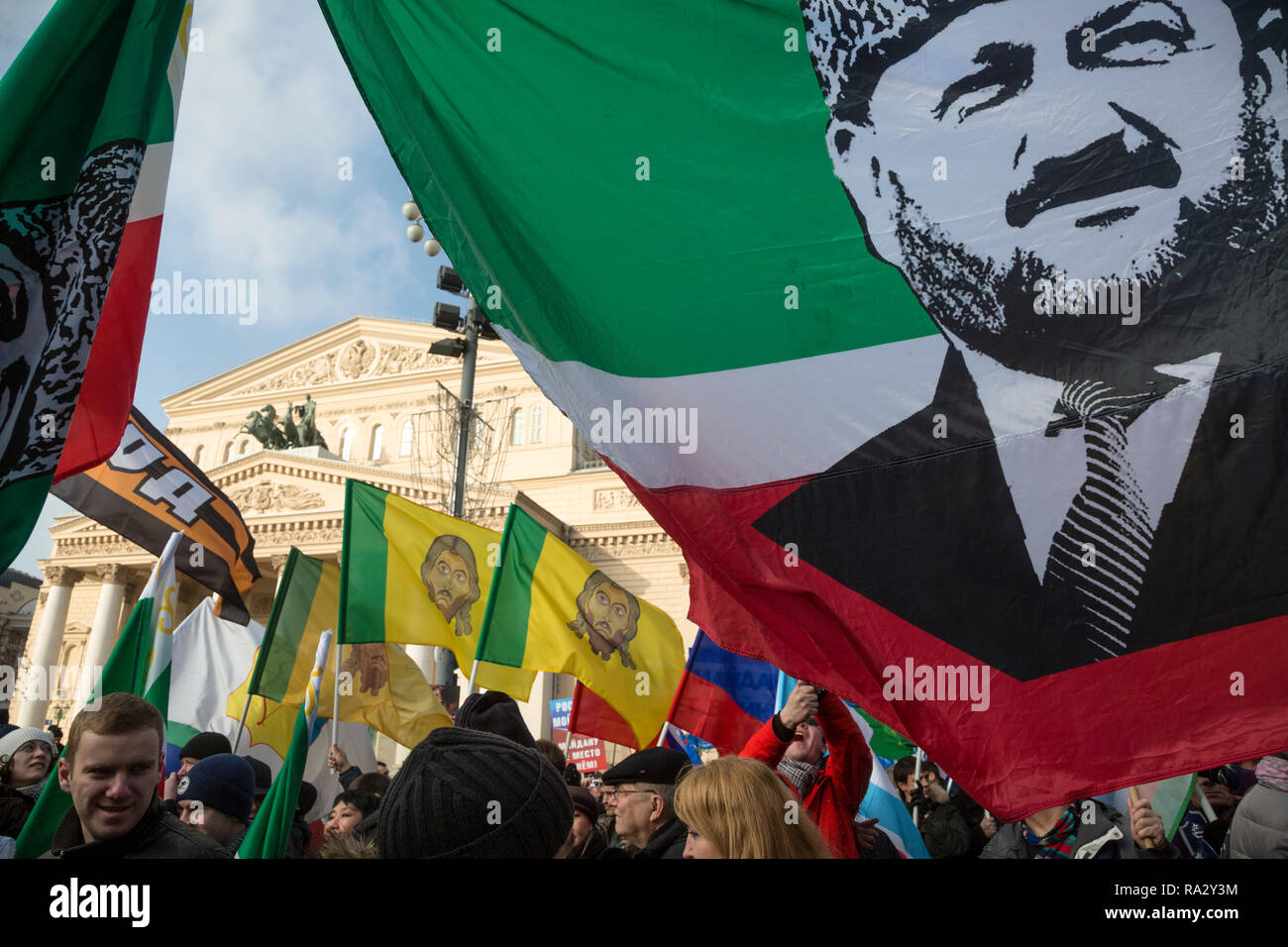 Participants of the March movement 'Anti-Maidan' holding a flag of the Chechen Republic with a portrait of Akhmat Kadyrov in center of Moscow Stock Photo