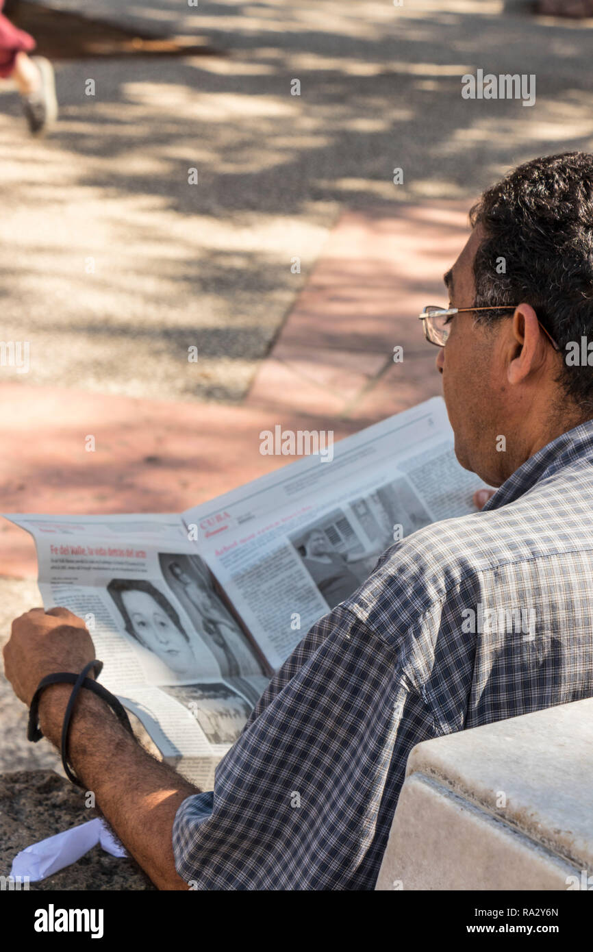 man reading local newspaper in Havana, Cuba, Caribbean Stock Photo