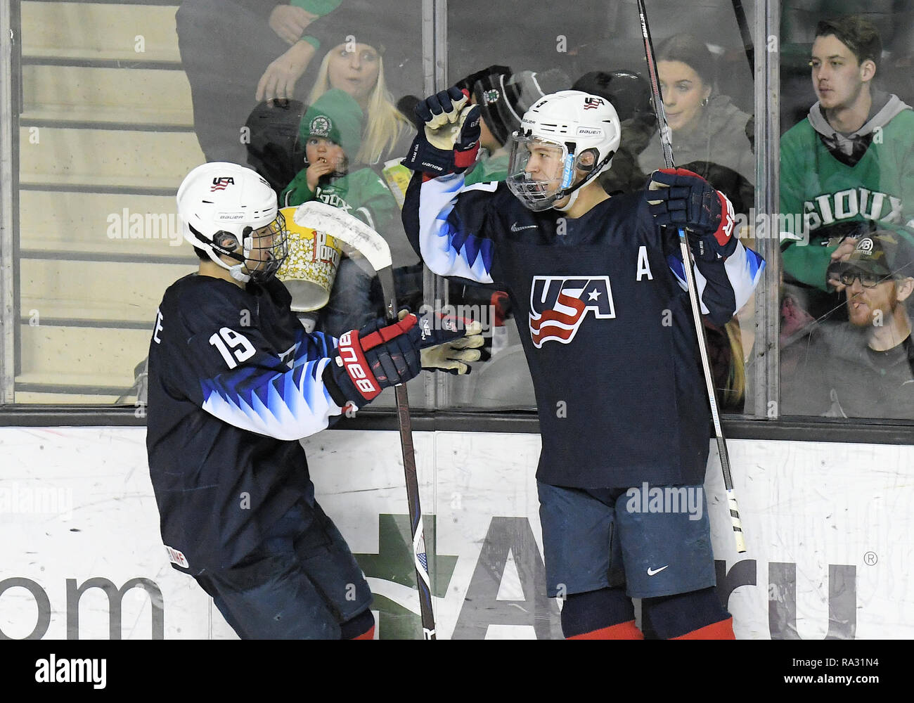 December 29, 2018 US National Under 18 team forward Alex Turcotte (19) congratulates US National Under 18 team's Matthew Boldy (9) on his goal during a exhibition men's college hockey game between the U.S. National Under-18 team and the University of North Dakota Fighting Hawks at Ralph Engelstad Arena in Grand Forks, ND. UND won 6-2. Photo by Russell Hons/CSM Stock Photo