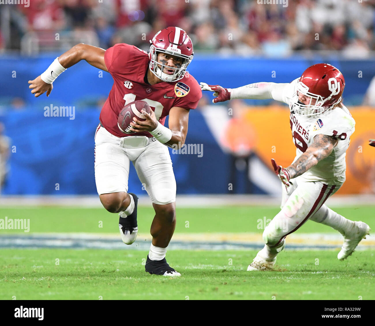 Alabama Crimson Tide quarterback Tua Tagovailoa (13) hands off to Alabama  Crimson Tide running back Josh Jacobs (8) in the fourth quarter during the  college football playoff semifinal at the Capital One