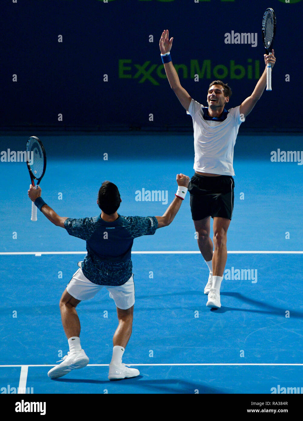 Doha, Qatar. 31st Dec, 2018. Marko Djokovic (R) and Novak Djokovic of  Serbia celebrate during a doubles match against Mubarak Shannan Zayid of  Qatar and Cem Ilkel of Turkey at the ATP