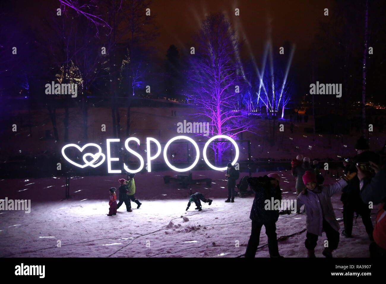 (190101) --ESPOO, Jan. 1, 2019 (Xinhua) -- People play in the park decorated with light arts during a massive laser show held to celebrate the New Year in the city of Espoo, Finland, on Dec. 31, 2018. Espoo becomes the first city in Finland to replace fireworks with laser show when celebrating the New Year. The public demand for banning the use of fireworks is constantly rising in recent years in Finland, aiming to reduce the cases of injuries, air pollution and stress and anxiety in animals caused by fireworks. (Xinhua/Li Jizhi) Stock Photo