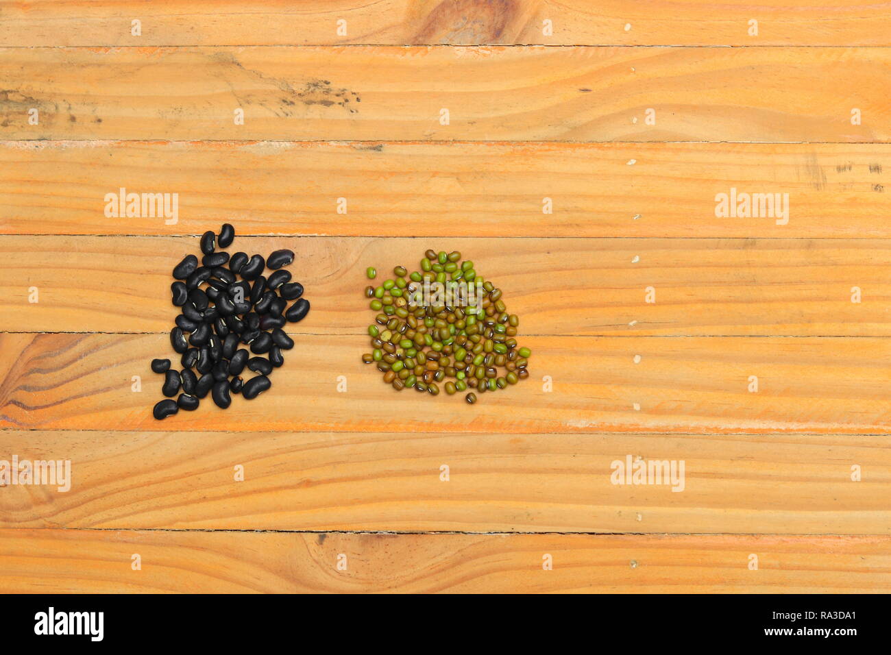 black and green beans closeup on wood floor background Stock Photo - Alamy