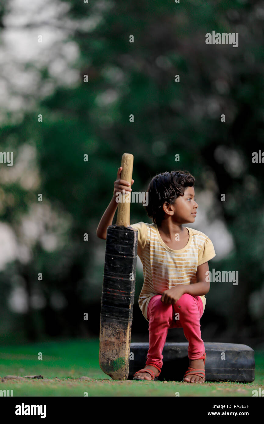 indian girl child playing cricket Stock Photo