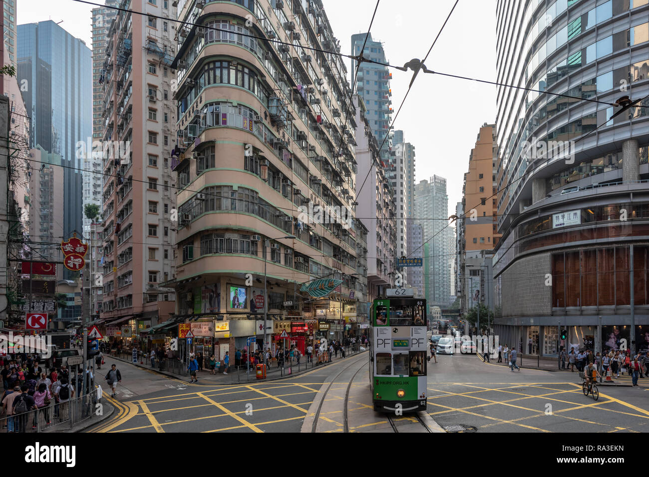 A tram to Happy Valley crosses the junction of Johnston, Wan Chai and Fleming Roads in bustling Wan Chai. Stock Photo
