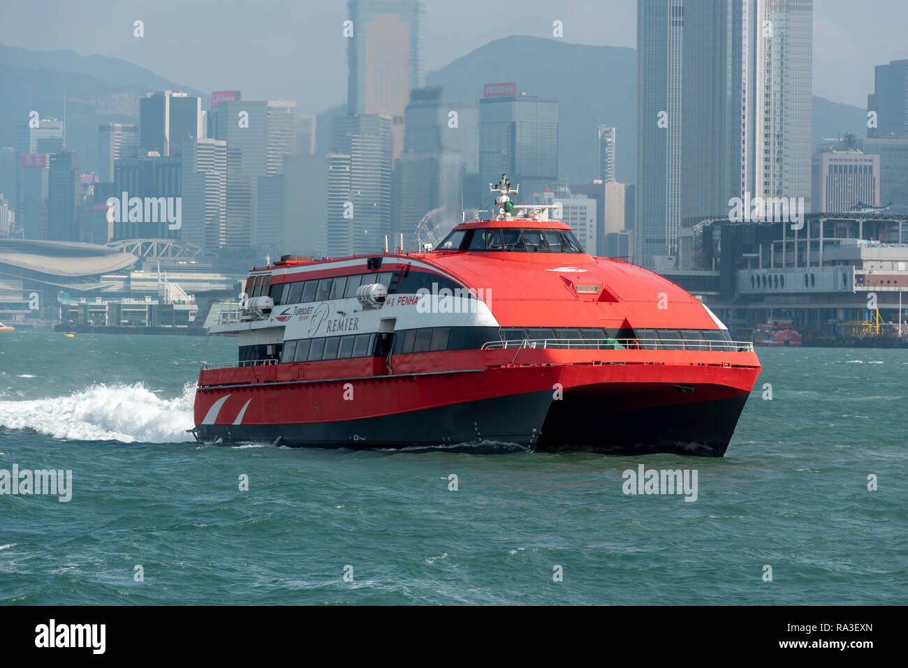 The TurboJet catamaran hydrofoil 'Penha' navigating Victoria Harbour en route to Macau with the skyscrapers of Wan Chai District in the background Stock Photo
