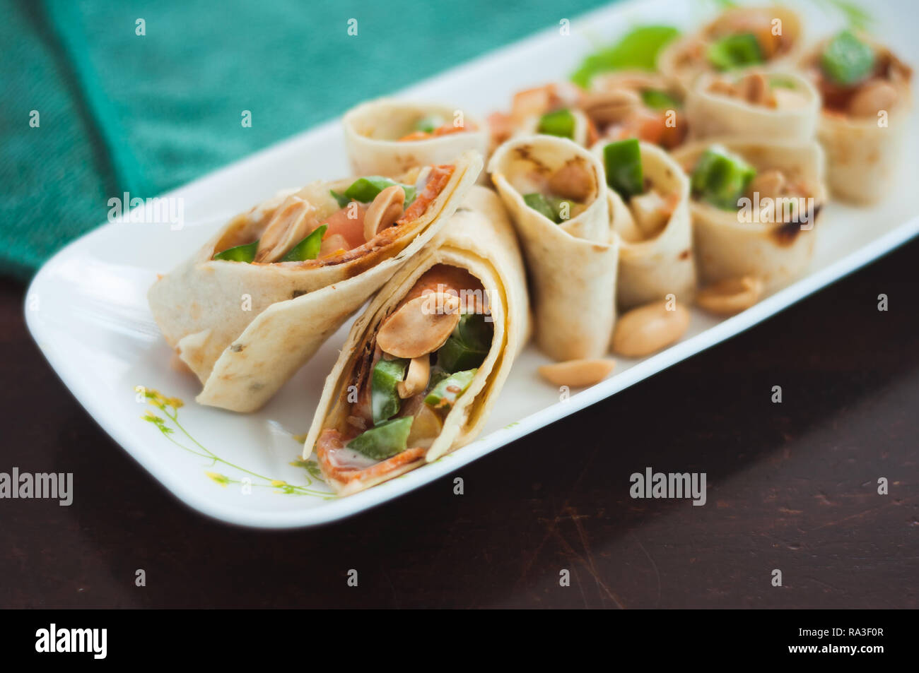 Sushi-Style Wraps with chicken pepperoni, vegetables and nuts. Healthy snacks. Stock Photo