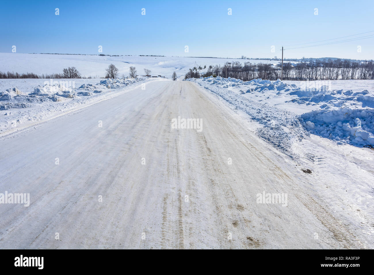 Snowy icy road among the hills Stock Photo