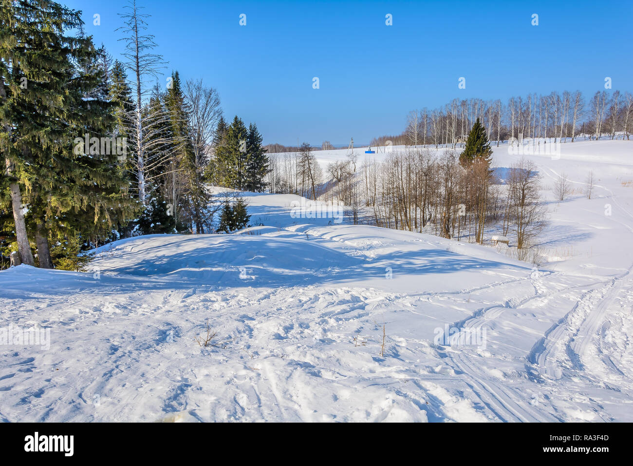Snowy hills in winter sunny day Stock Photo