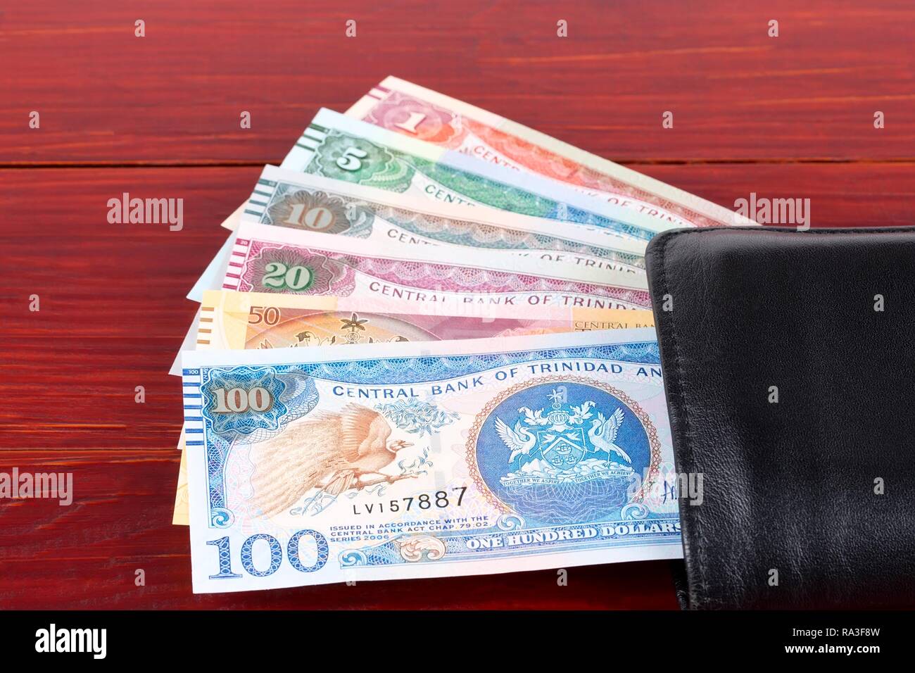 Money from Trinidad and Tobago in the black wallet Stock Photo Alamy