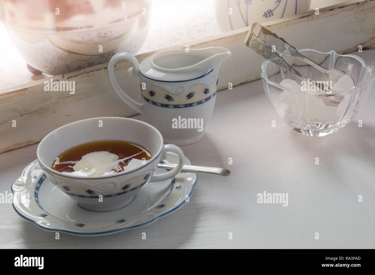 East frisian tea time. Cup of hot tea served on a wodden table. Stock Photo
