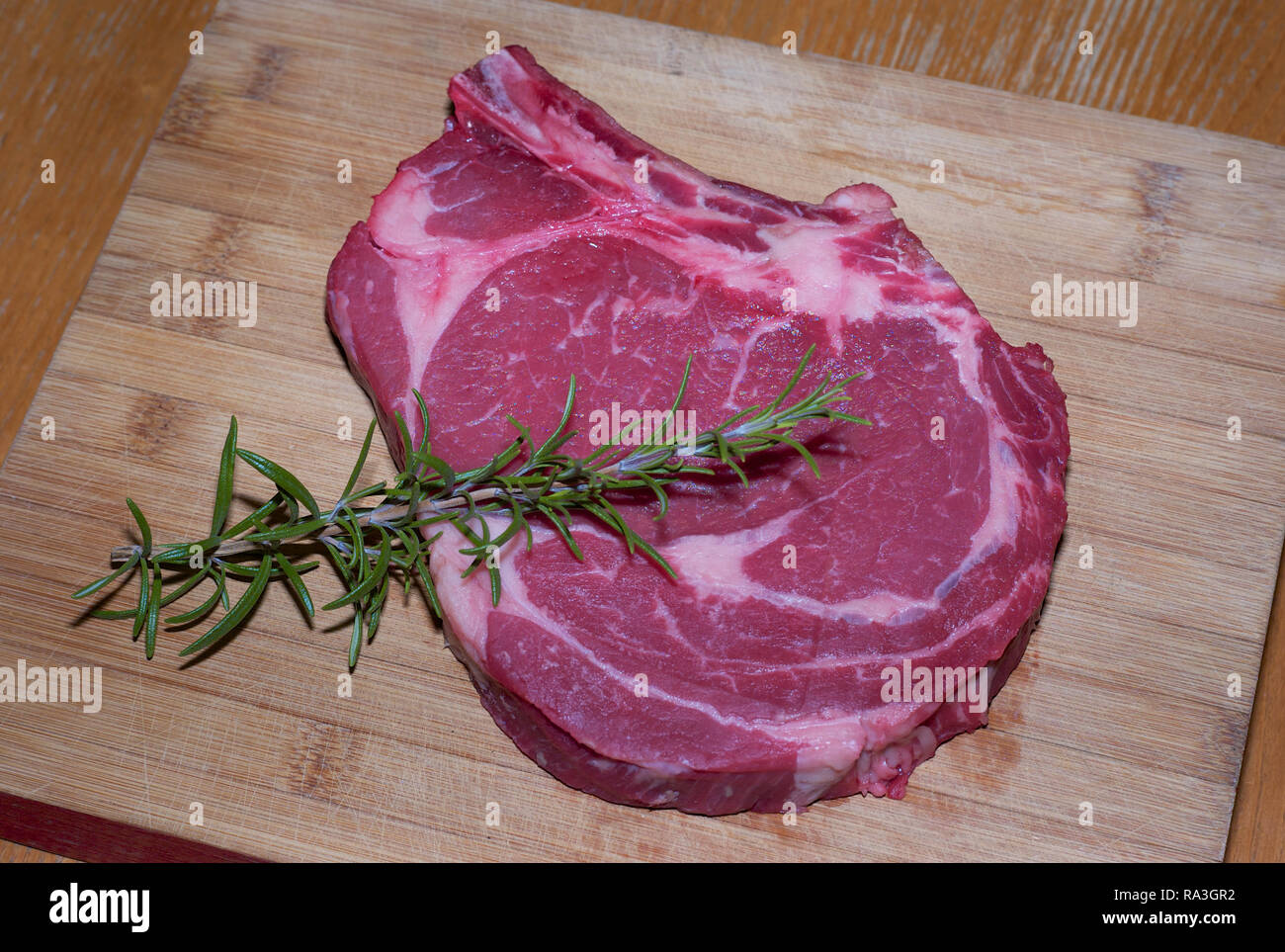Raw Prime Rib of Beef on a Wooden Board Stock Photo