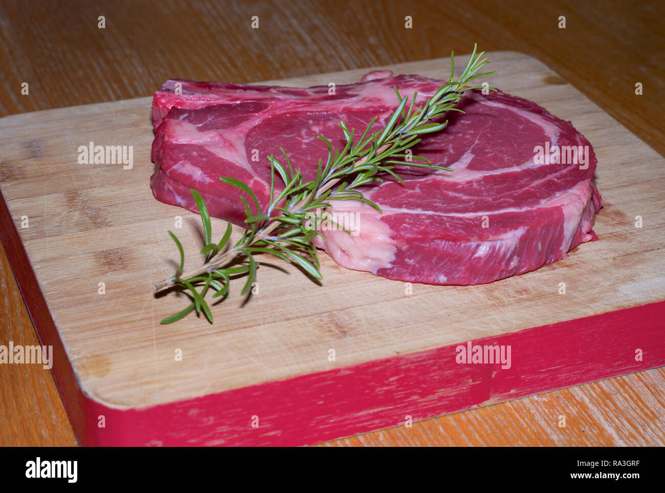 Raw Prime Rib of Beef on a Wooden Board Stock Photo