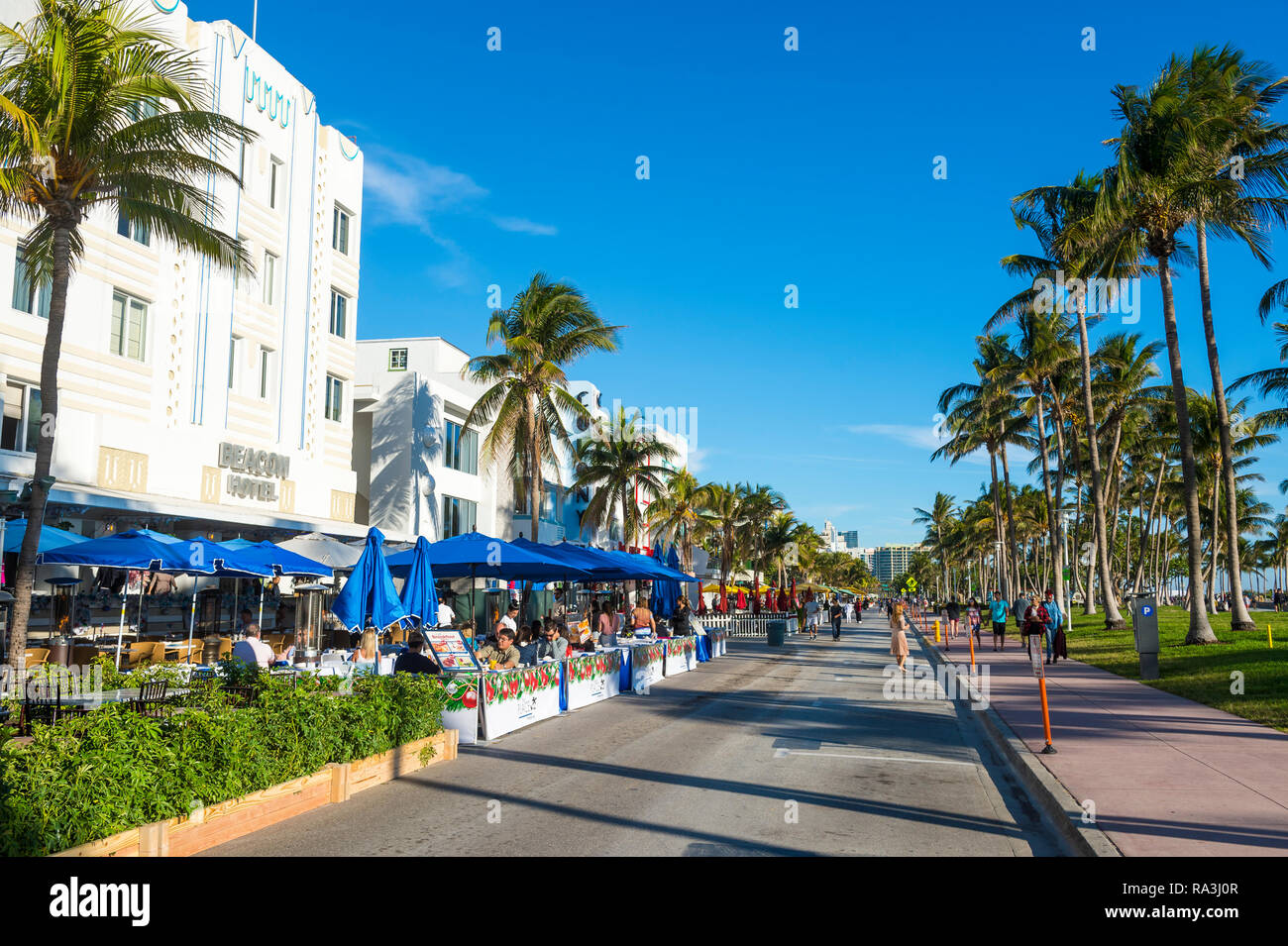 MIAMI - JANUARY, 2018: Sidewalk cafes expand onto the street when the Ocean Drive tourist strip is closed to traffic during New Year holidays. Stock Photo