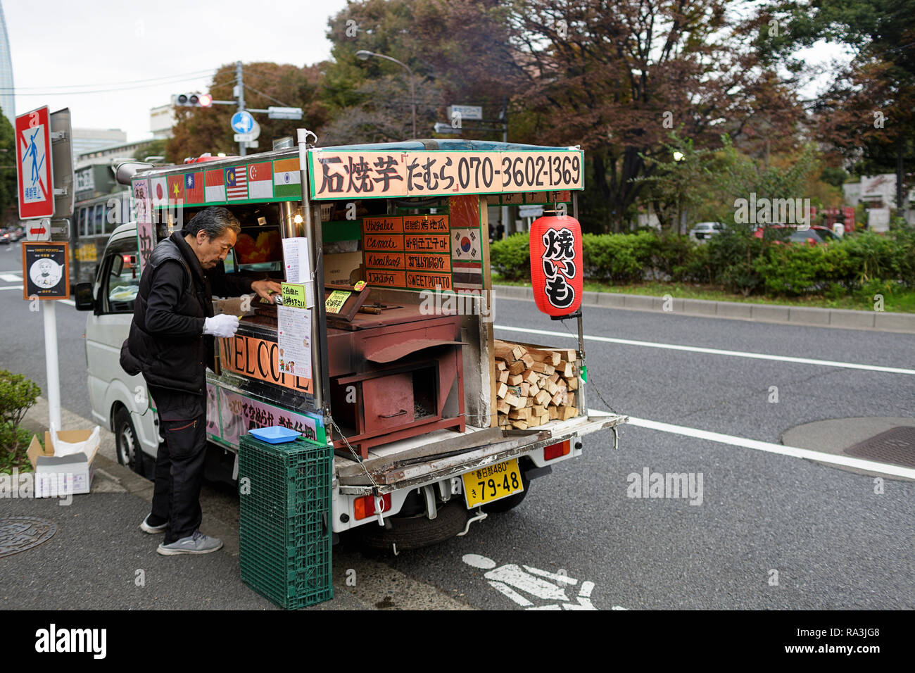Traditional Yaki Imo roasted sweet potato vendor and potato topped