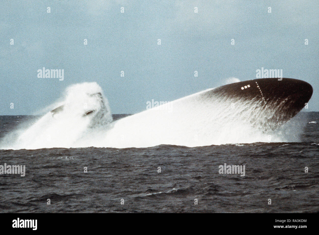 1978 - A starboard view of the nuclear-powered attack submarine BIRMINGHAM (SSN-695) conducting an emergency surfacing exercise during sea trials. Stock Photo