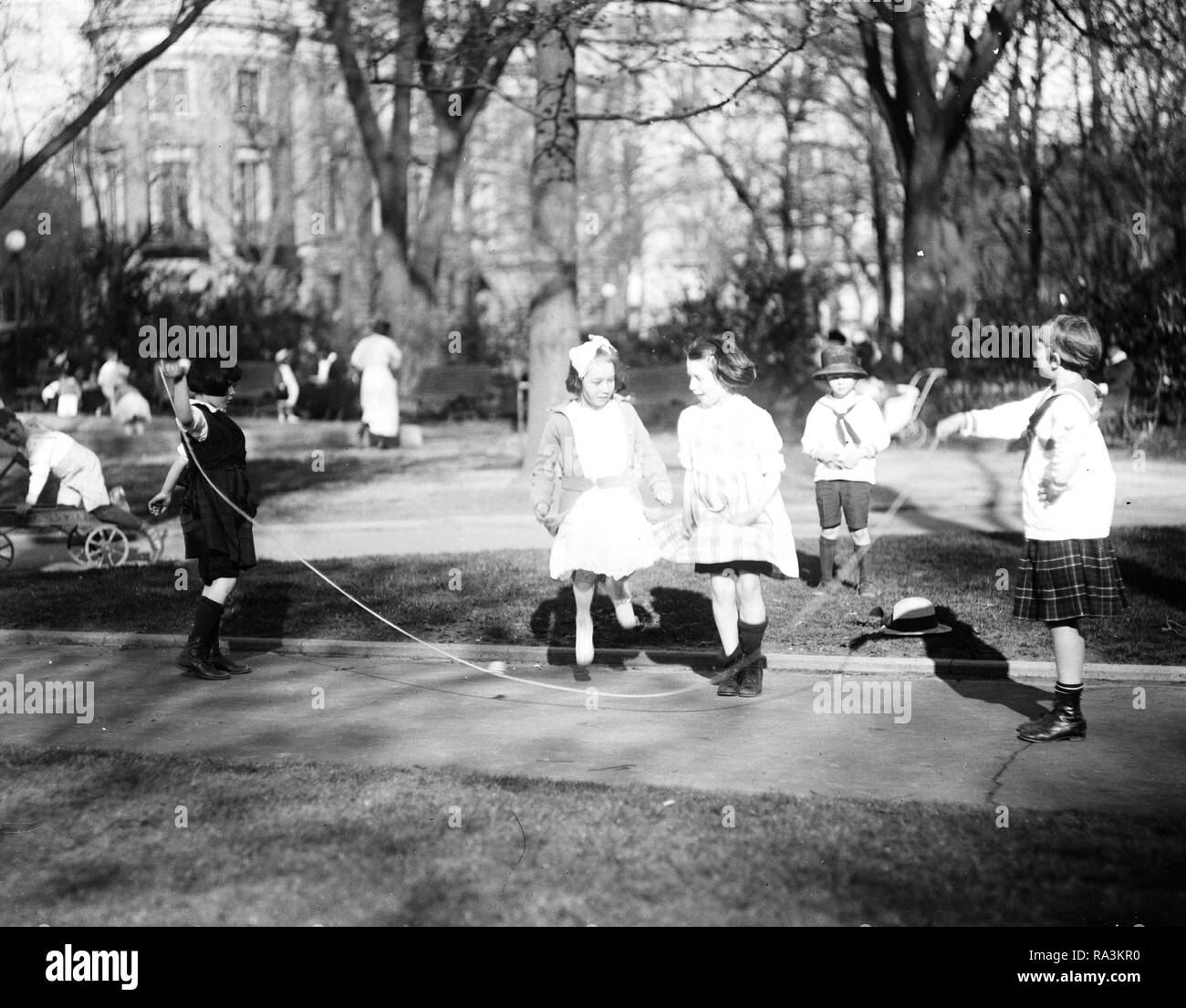Children playing in park early 1900s hires stock photography and
