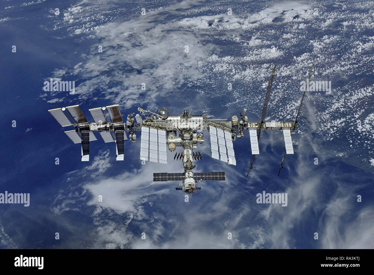 The International Space Station orbits over the earth December 20, 2018 in Earth Orbit. The orbiting laboratory has been inhabited by an international crew of Russians, Americans, Canadians, Japanese and European astronauts and researchers continuously since 1998. Stock Photo