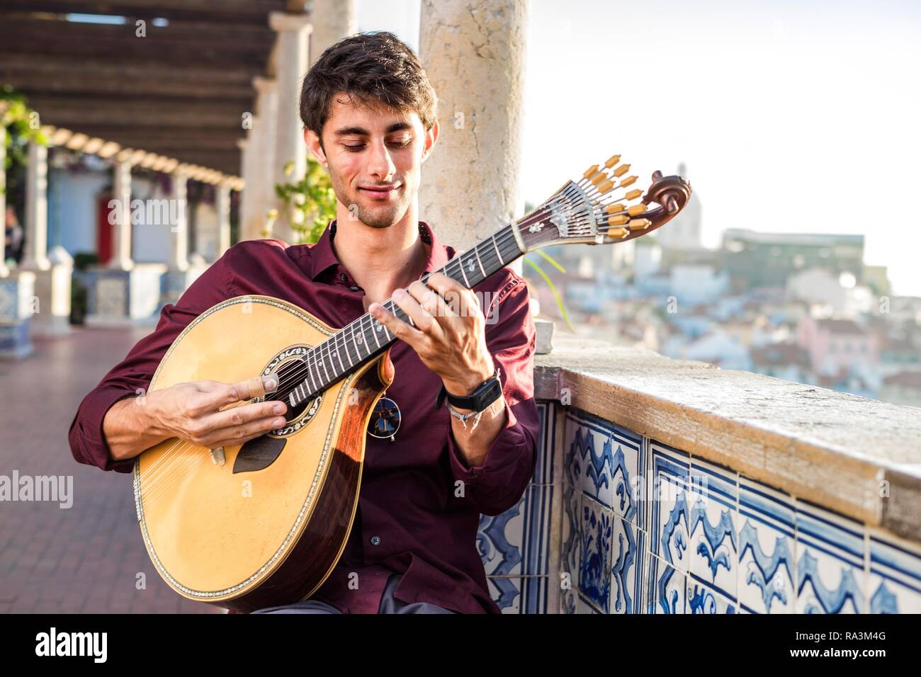 Fado musician playing on unique portuguese guitar in Alfama, Lisbon, Portugal Stock Photo
